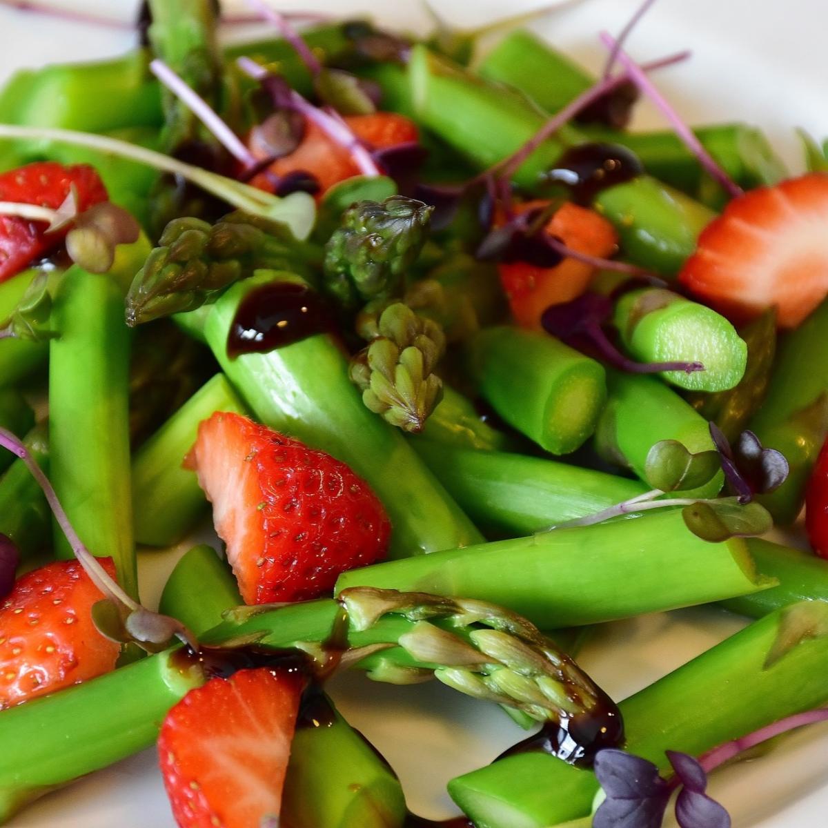 Fresh slices of asparagus and strawberries