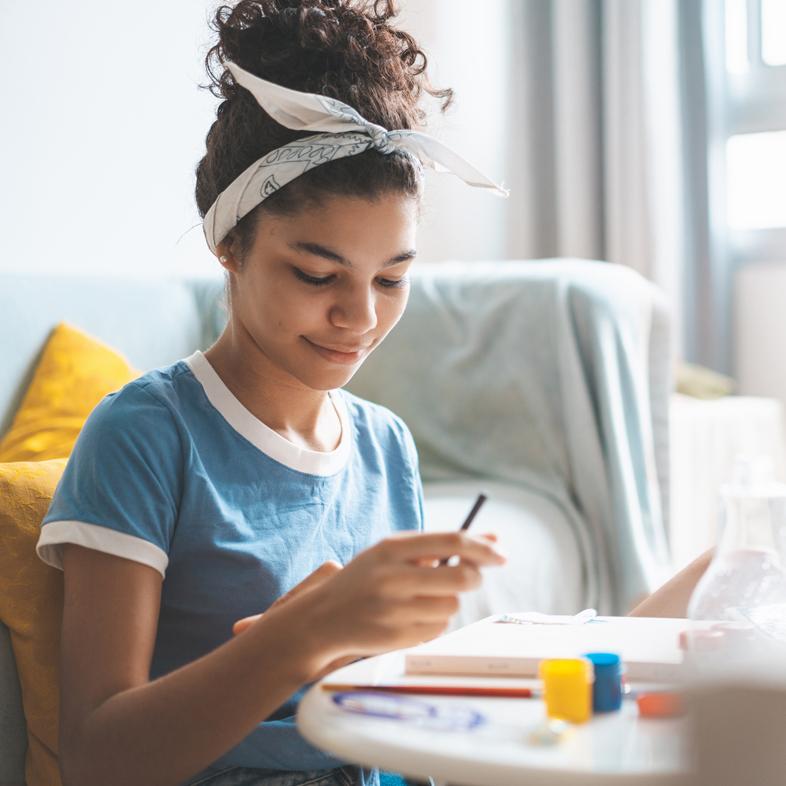 Teen crafting at a table