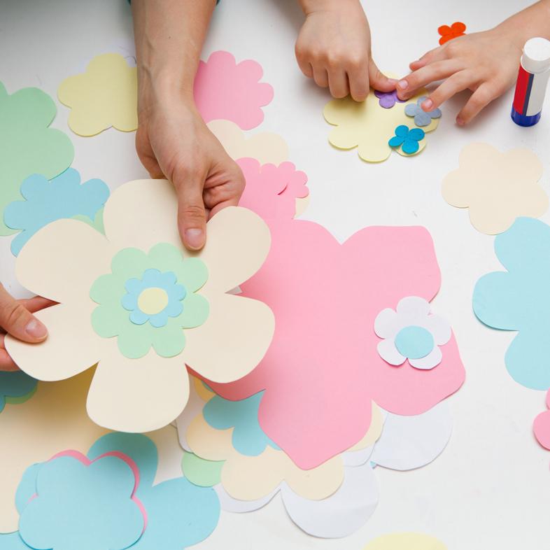 Parent and child working on paper flowers