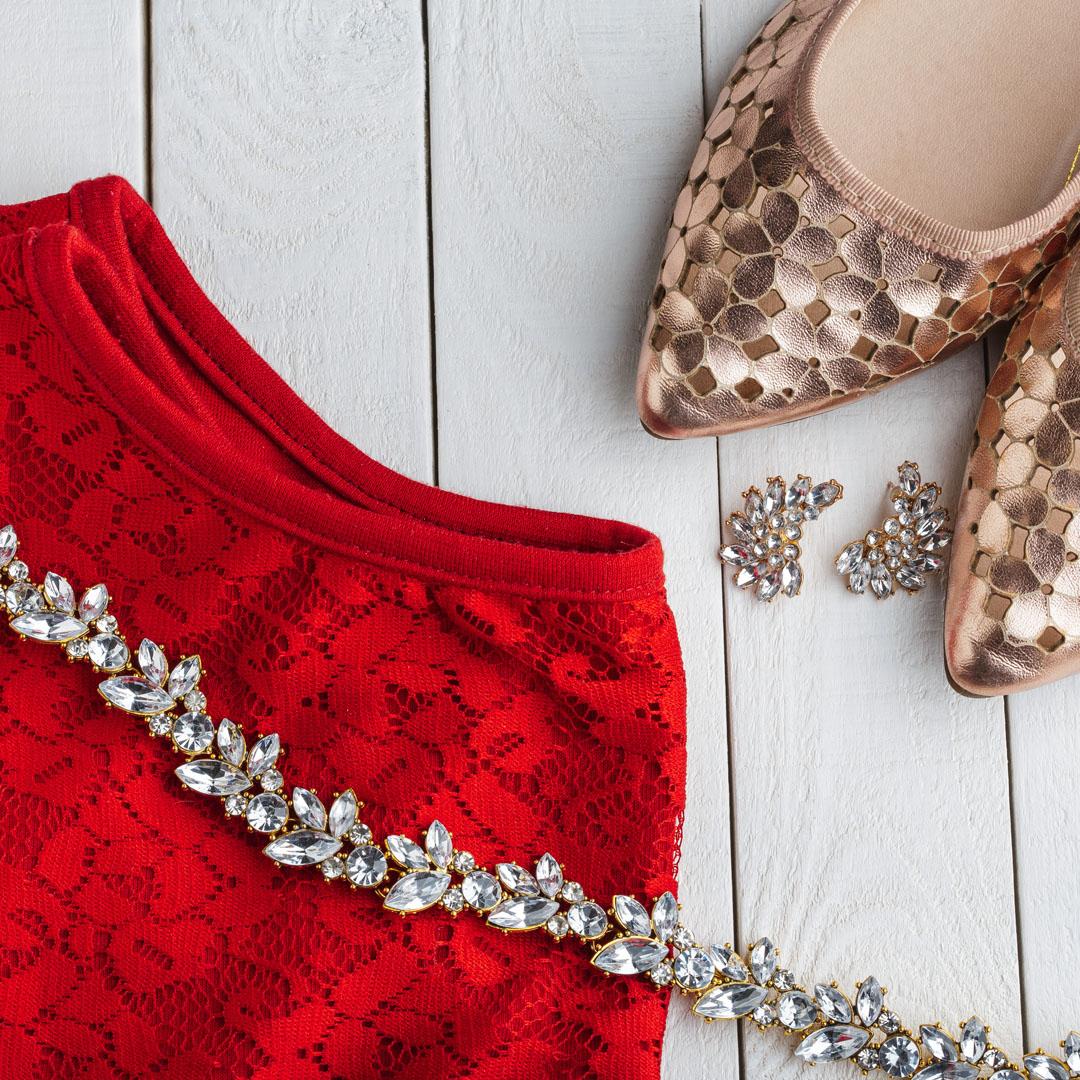 Red dress, gold shoes, and diamond necklace