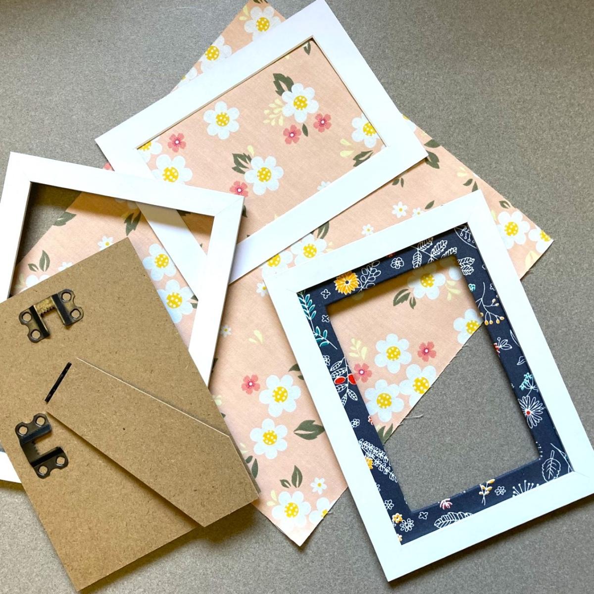 framed photo mat covered in fabric and craft supplies