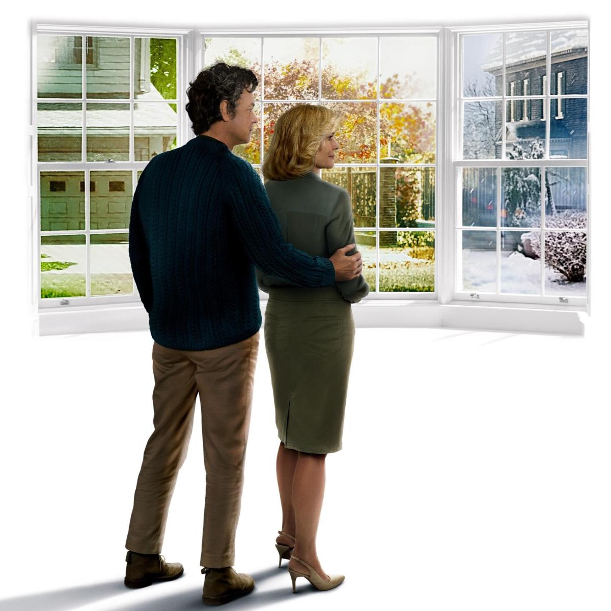 Couple looking out windows of home showing different seasons