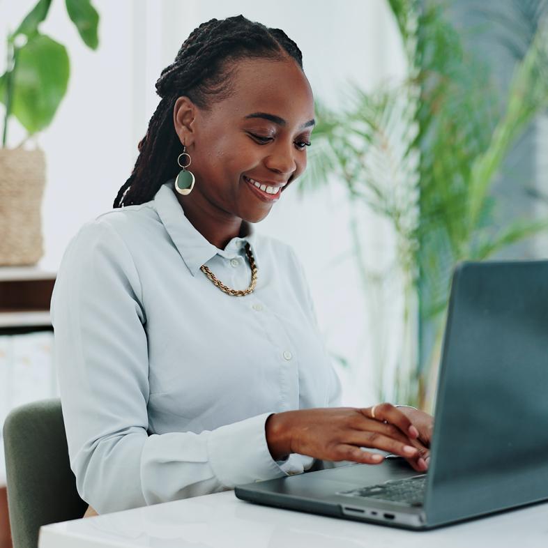 Woman smiling while typing on computer