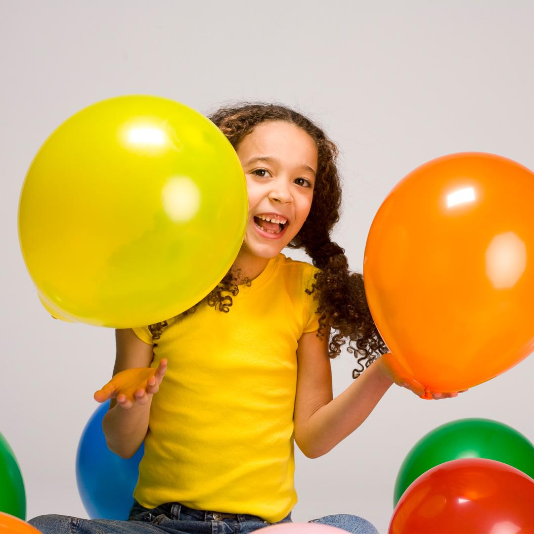 Child holding balloons