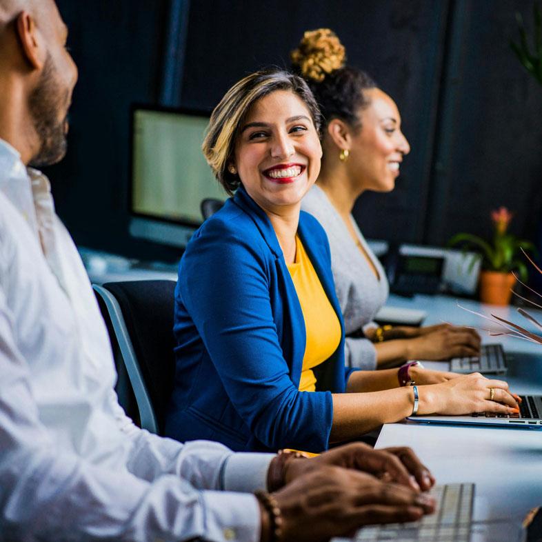 Team members smiling at eachother
