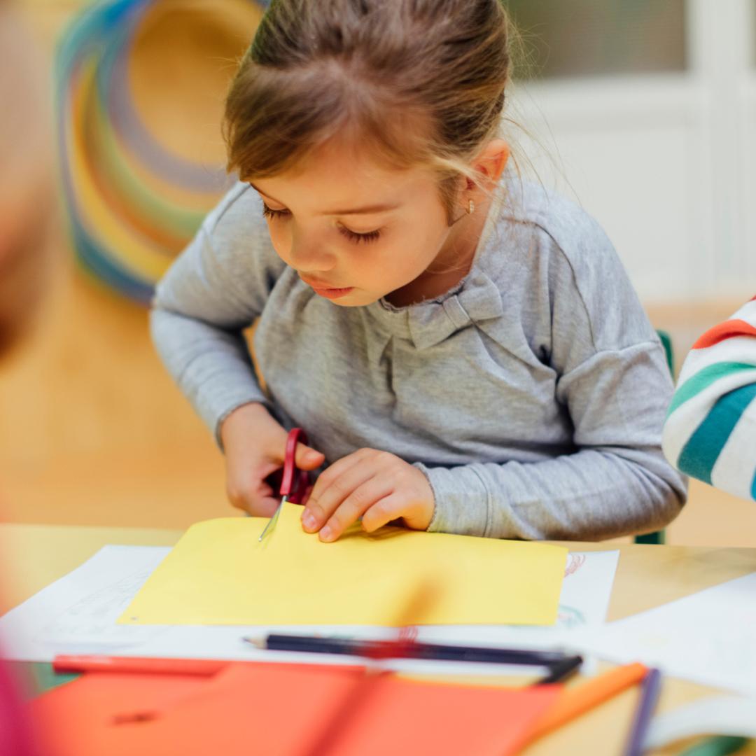 Preschooler cutting paper