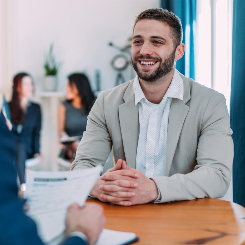 Young man smiling at a job interview