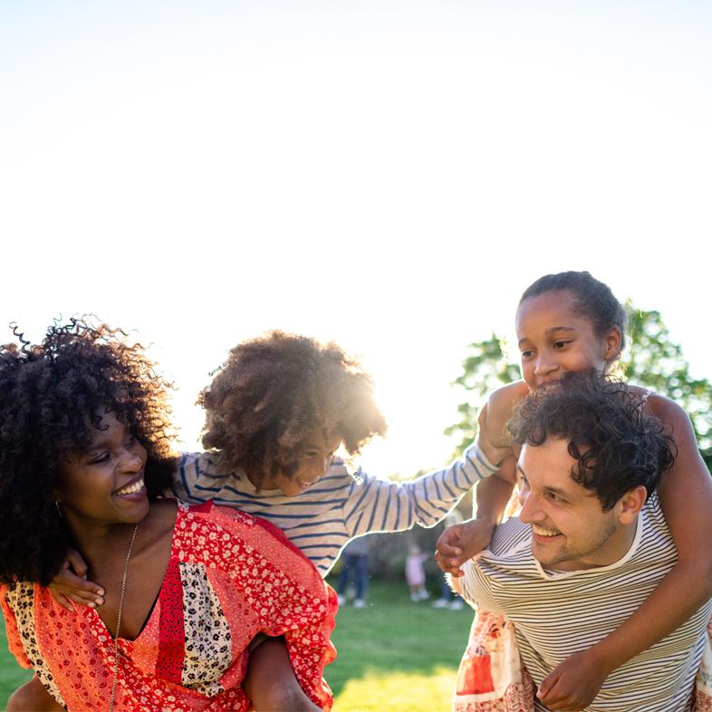 Family playing outside smiling