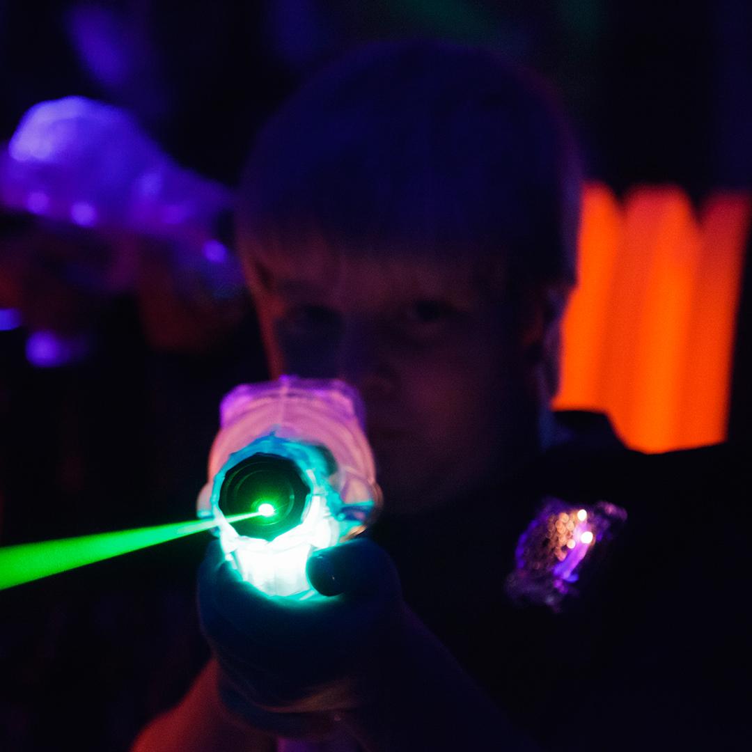 Boy holding laser tag blaster