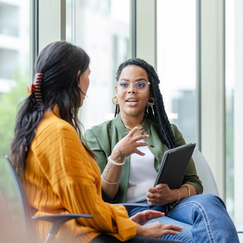Two women talking in waiting area