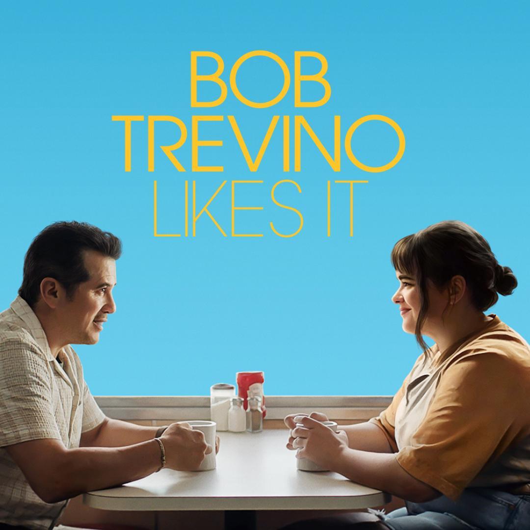 older man and young woman seated at restaurant booth