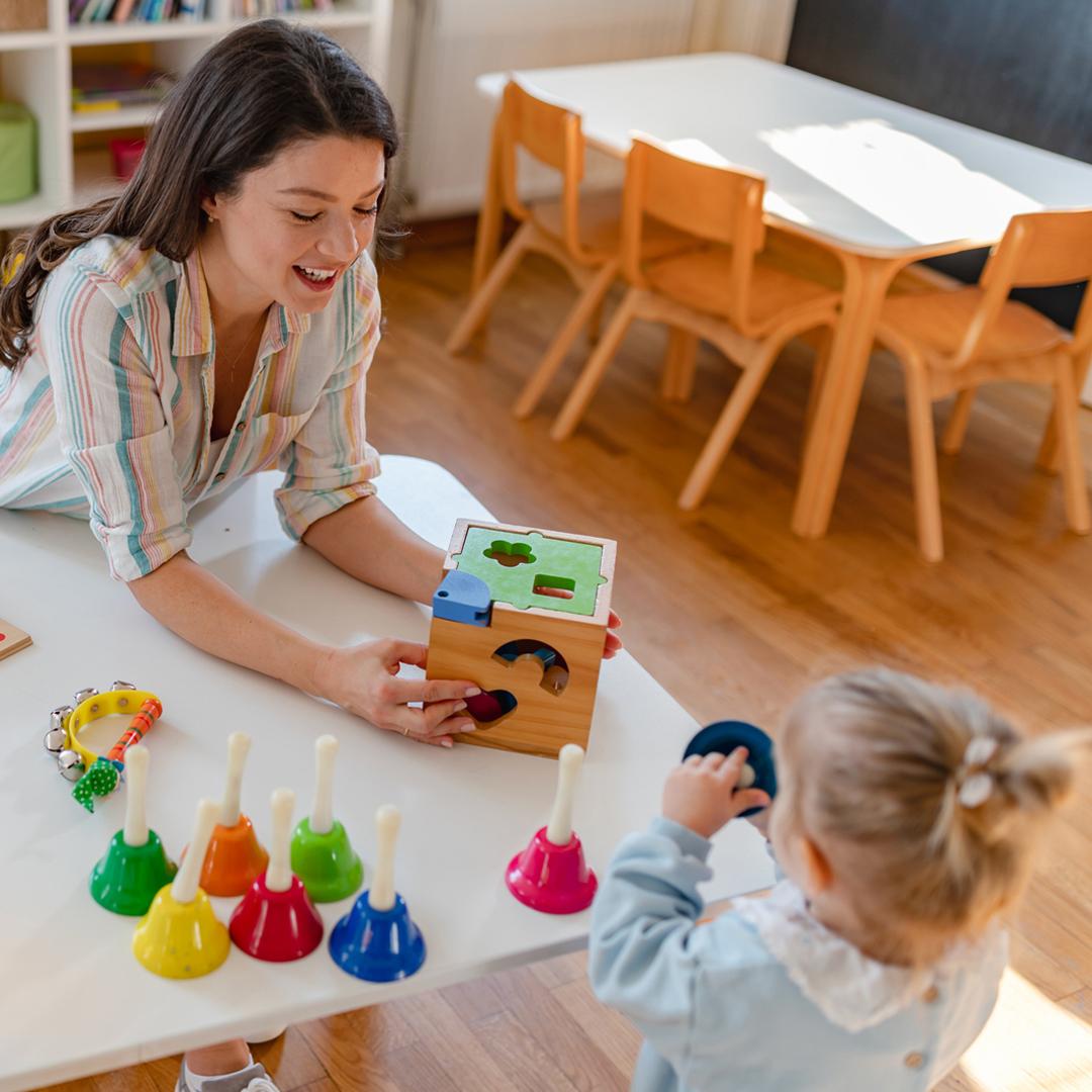 Child and teacher playing at a table