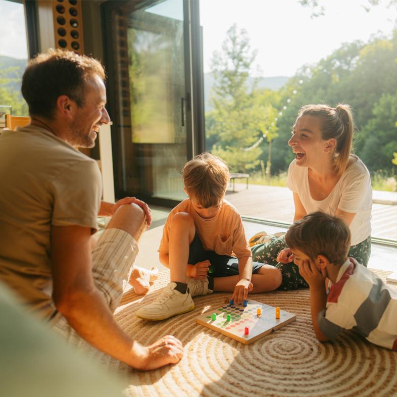 Family playing a board game on the ground