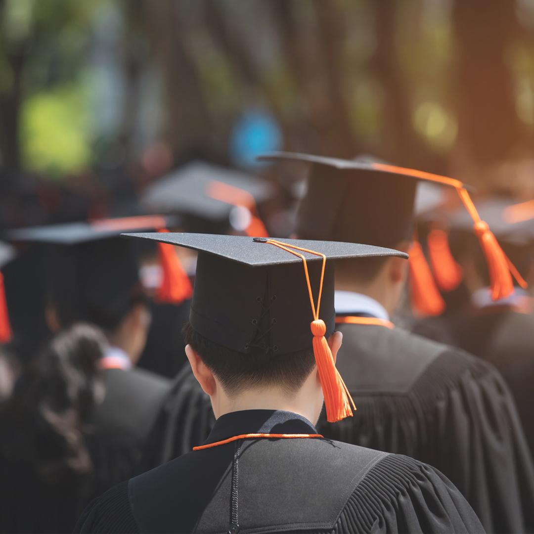 Students wearing graduation cap and gown