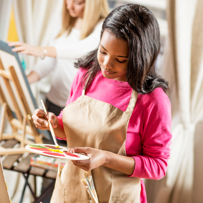 Teen painting on a easel