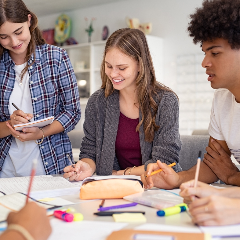 Teens sitting at a table studying