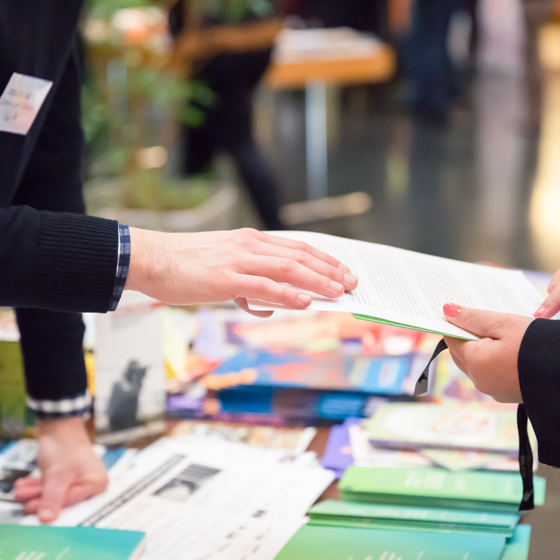 Hand taking something from info table