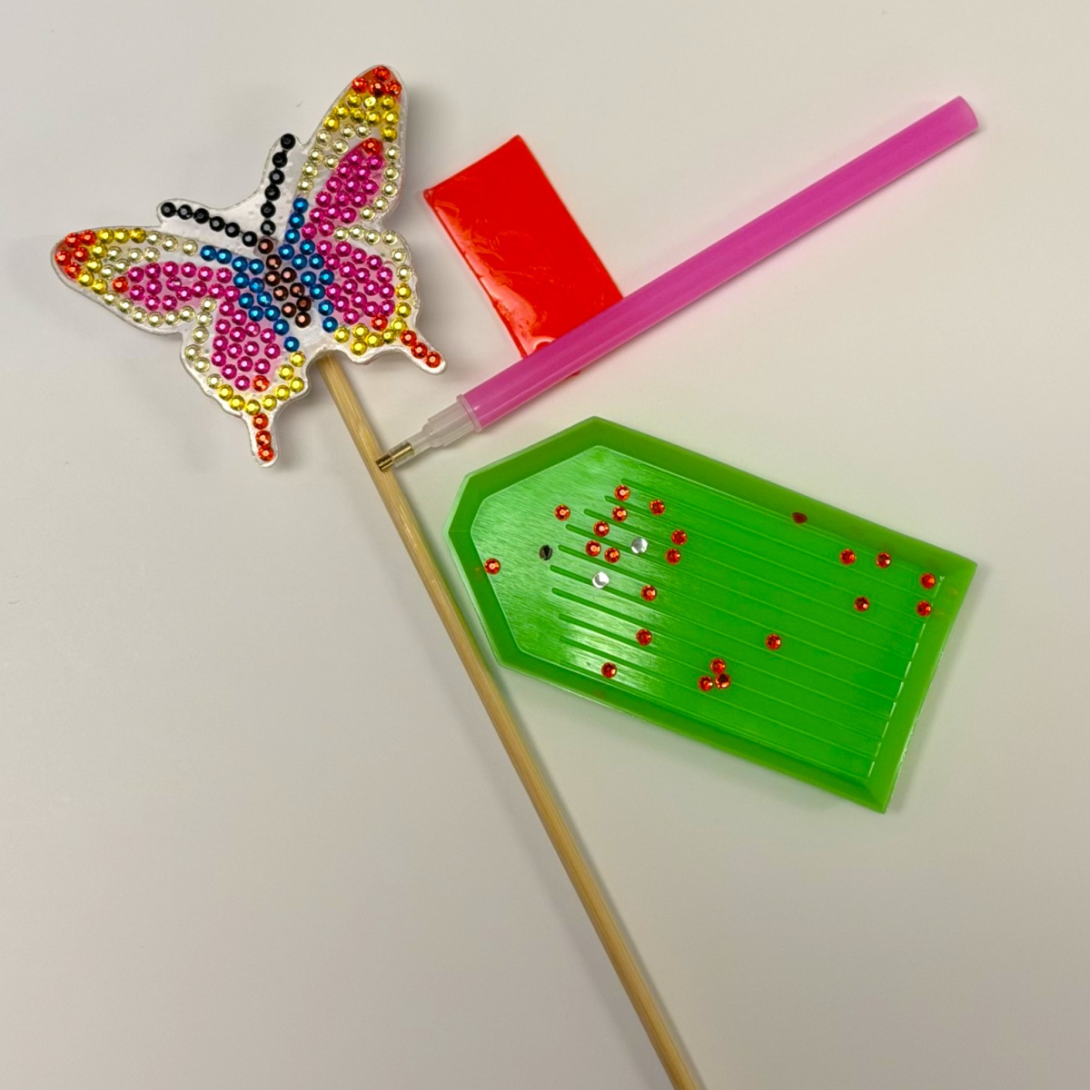 tools to make butterfly shaped plant stake decorated with sparkly beads