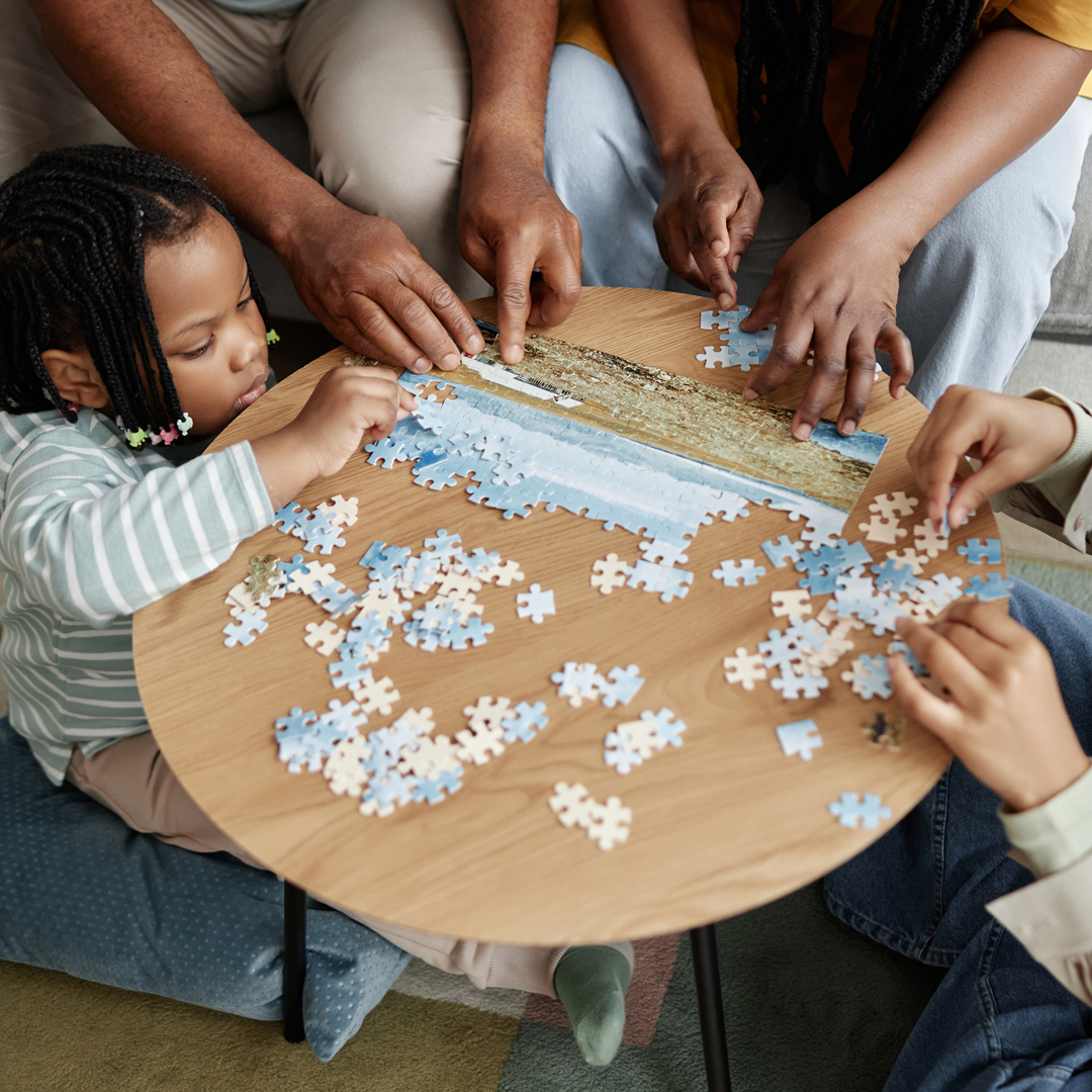 Family working on a puzzle at a table