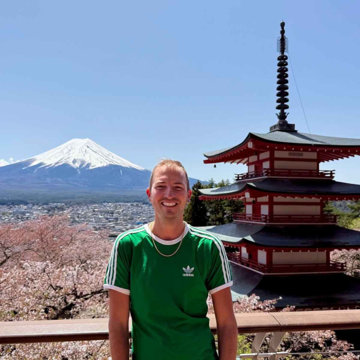 Presenter in front of pagoda, cherry blossoms and Mt. Fuji, Japan